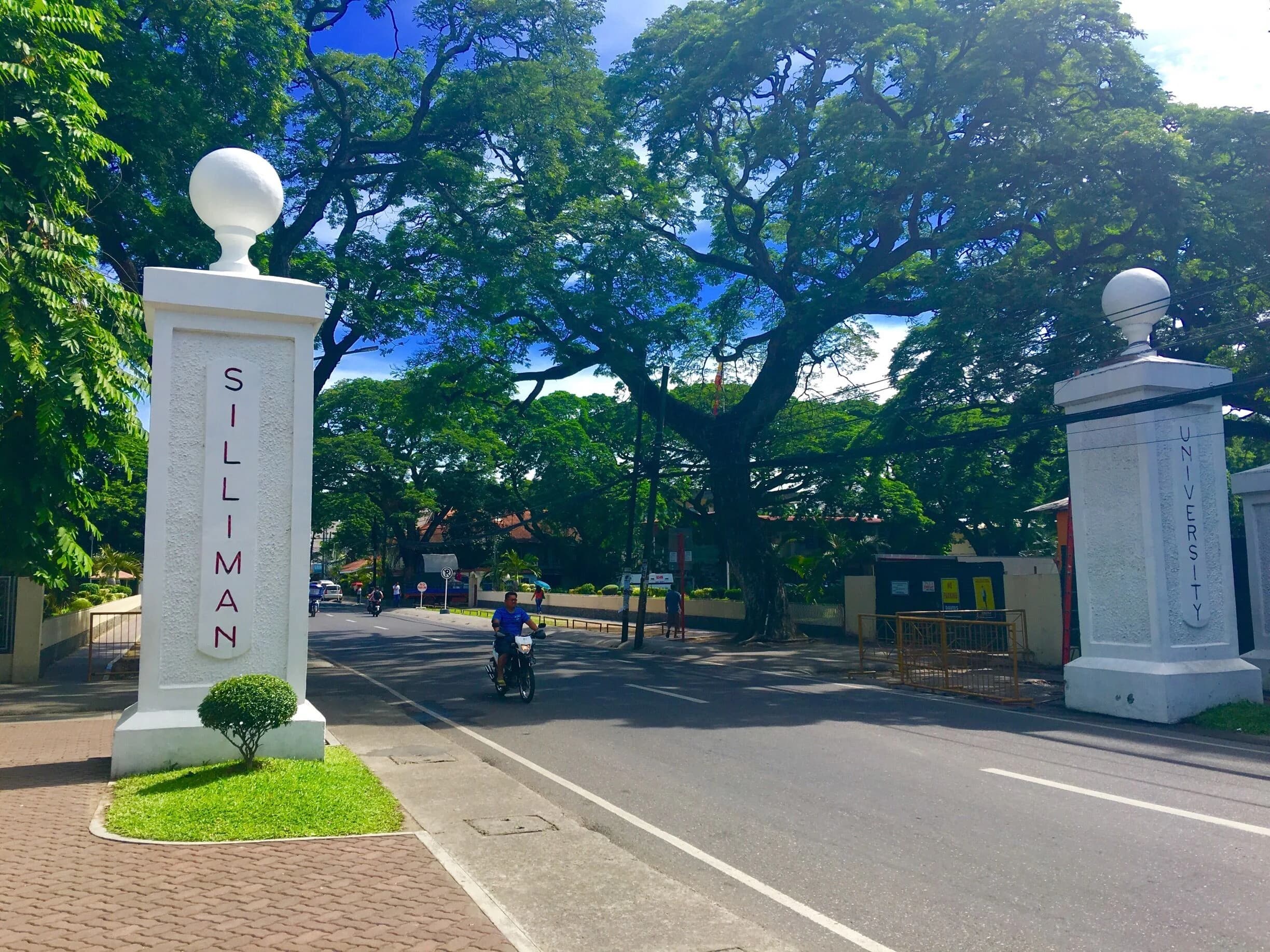 The white entrance pillars of Silliman University along Hibbard Avenue